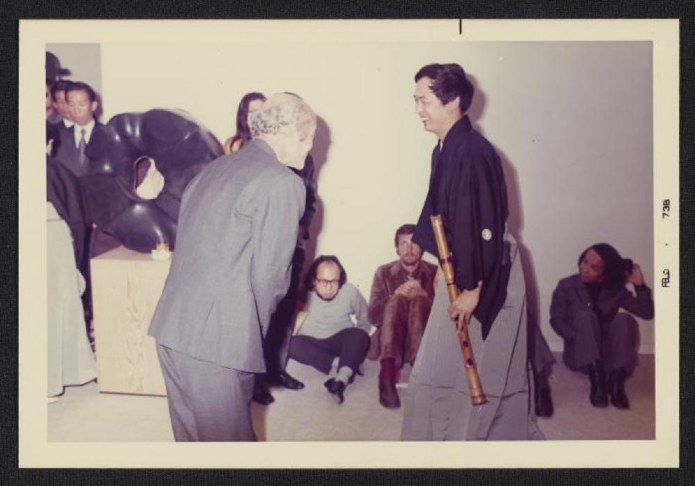 Noguchi with musician in front of Black Sun, exhibition opening, Minami Gallery, 1973