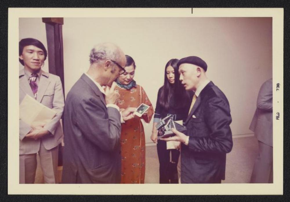 Noguchi with Michio Noguchi (beret) at exhibition opening, Minami Gallery, 1973