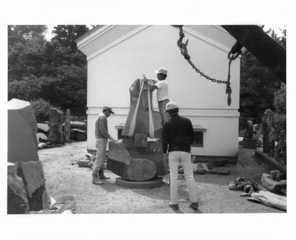 Masatoshi Izumi, Masami Sasao and another worker rigging a sculpture in the yard of Isamu Noguchi's studio in Mure, Shikoku, Japan