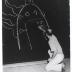 Isamu Noguchi writing his fathers poem Kane ga naru at his exhibition at Mitsukoshi Department Store, (Nihombashi Head Store), Tokyo,  August 1950