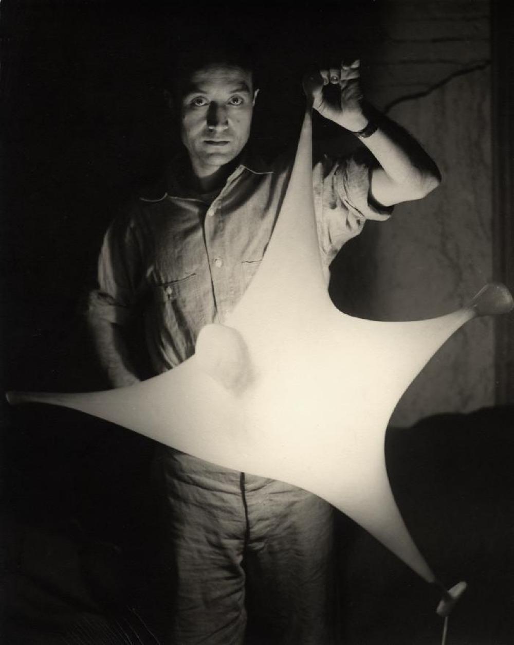 Isamu Noguchi with study for Luminous Plastic Sculpture, 1943