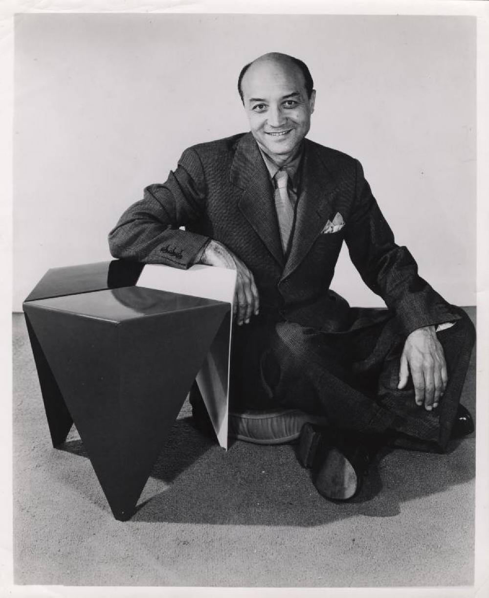 Isamu Noguchi with Prismatic Table in publicity shot for Alcoa