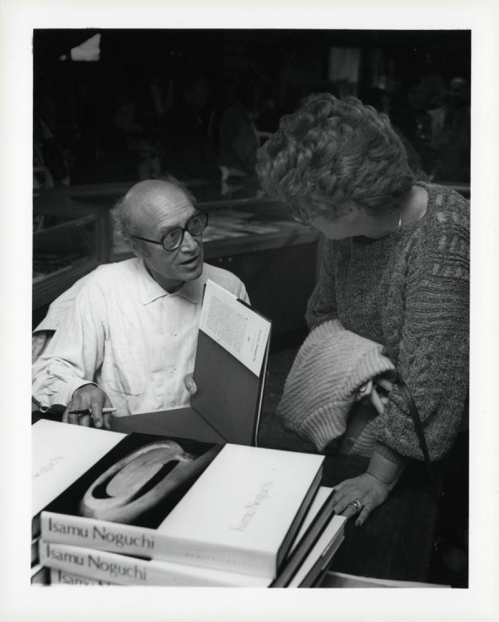 Noguchi signing catalogues at opening reception for "Noguchi's Imaginary Landscapes," Detroit Institute of Fine Arts, April 10 – June 10 1979 (travel from Walker Art Center).