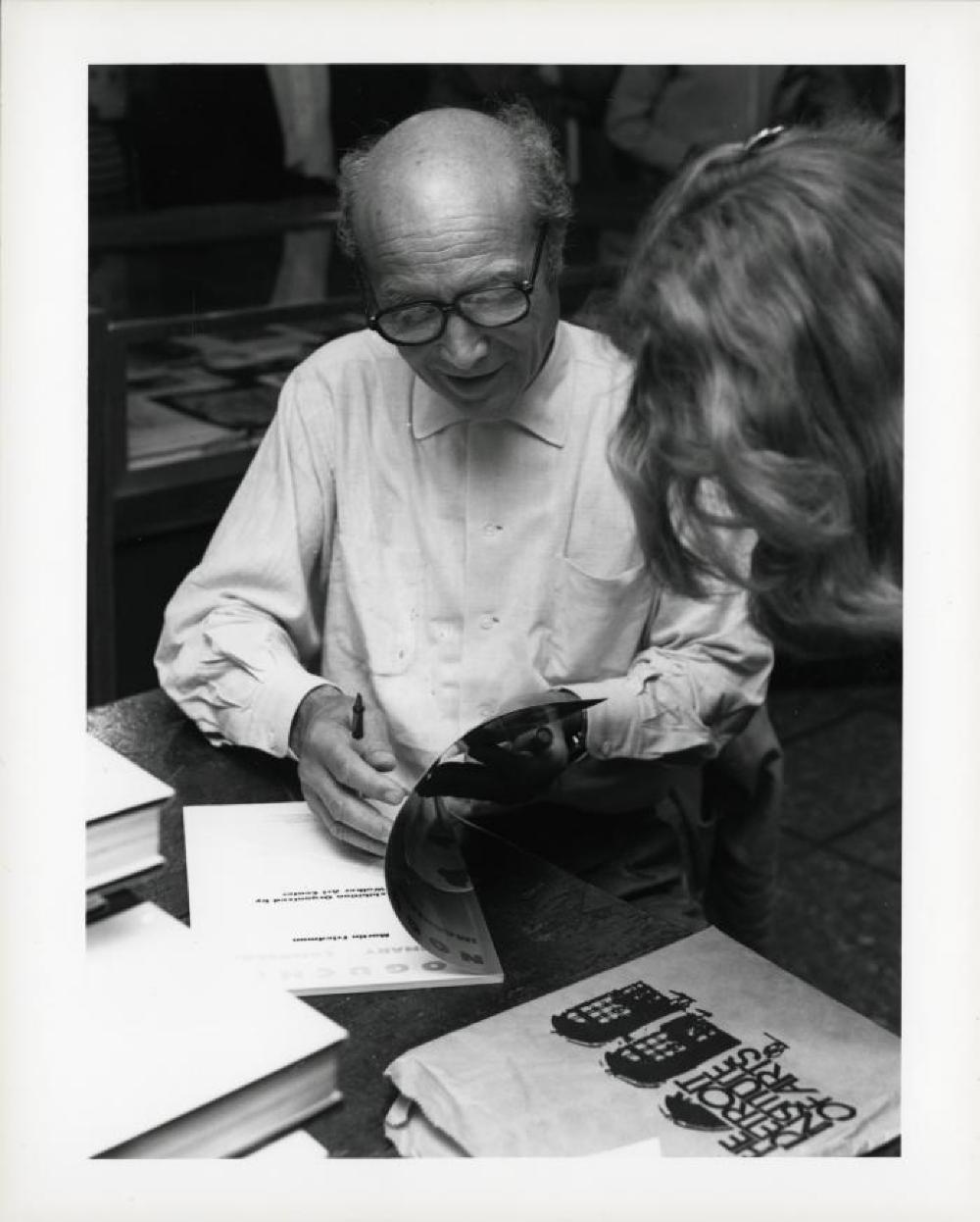 Noguchi signing catalogues at opening reception for "Noguchi's Imaginary Landscapes," Detroit Institute of Fine Arts, April 10 – June 10 1979 (travel from Walker Art Center).