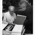 Noguchi signing catalogues at opening reception for Noguchis Imaginary Landscapes, Detroit Institute of Fine Arts, April 10 – June 10 1979 (travel from Walker Art Center).